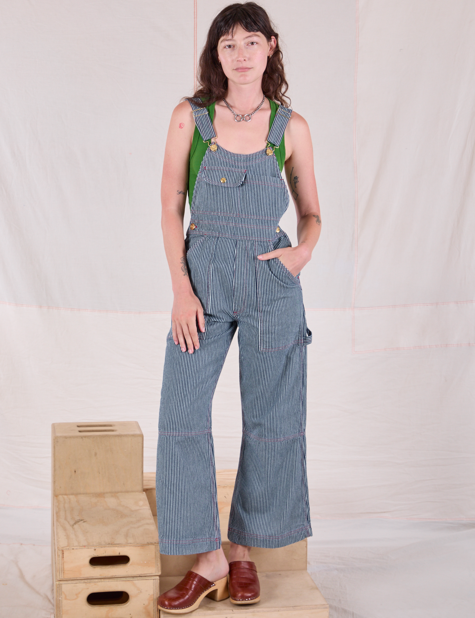 Alex is wearing Carpenter Overalls in Railroad