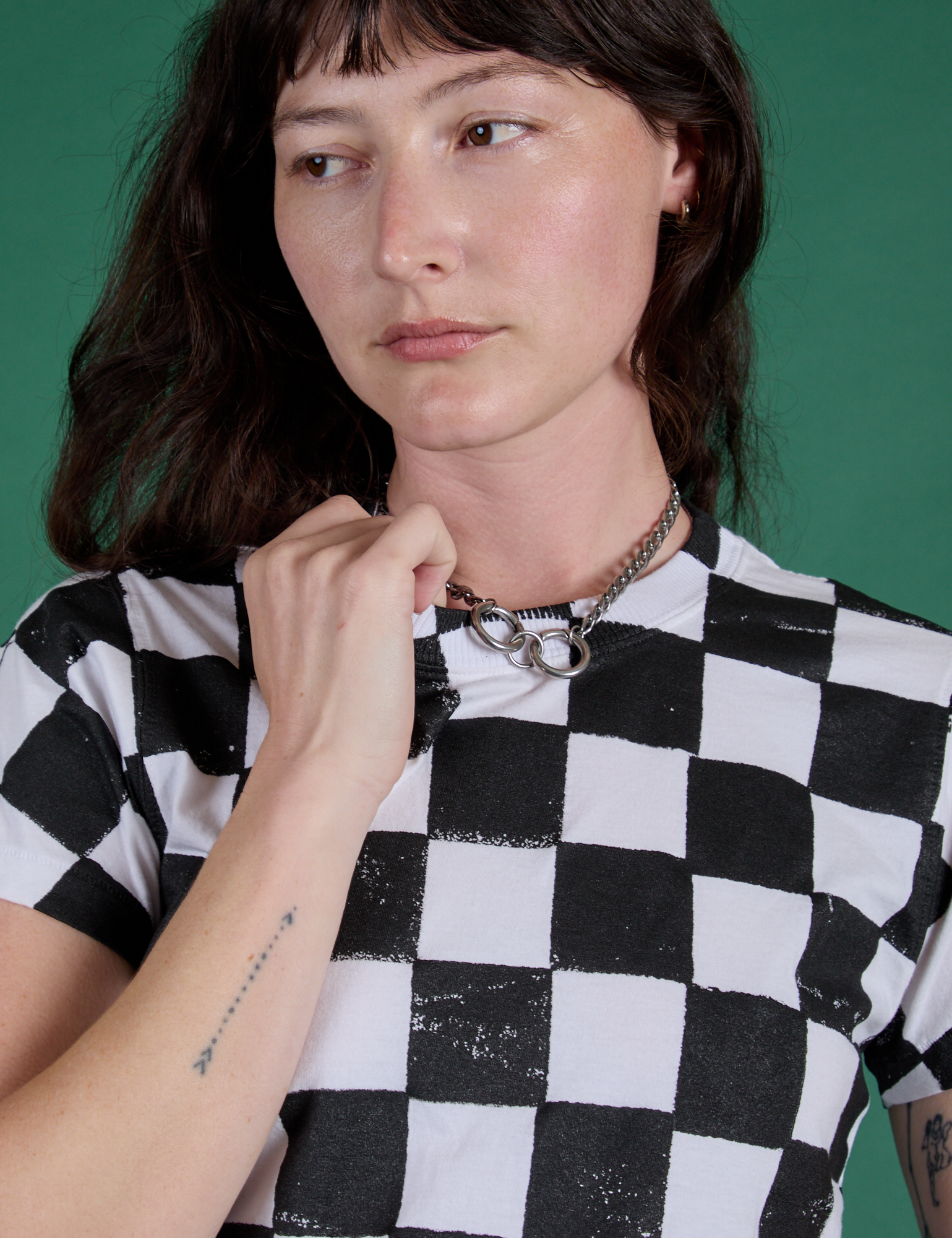 Front close up of Checker Organic Tee in Black on Alex