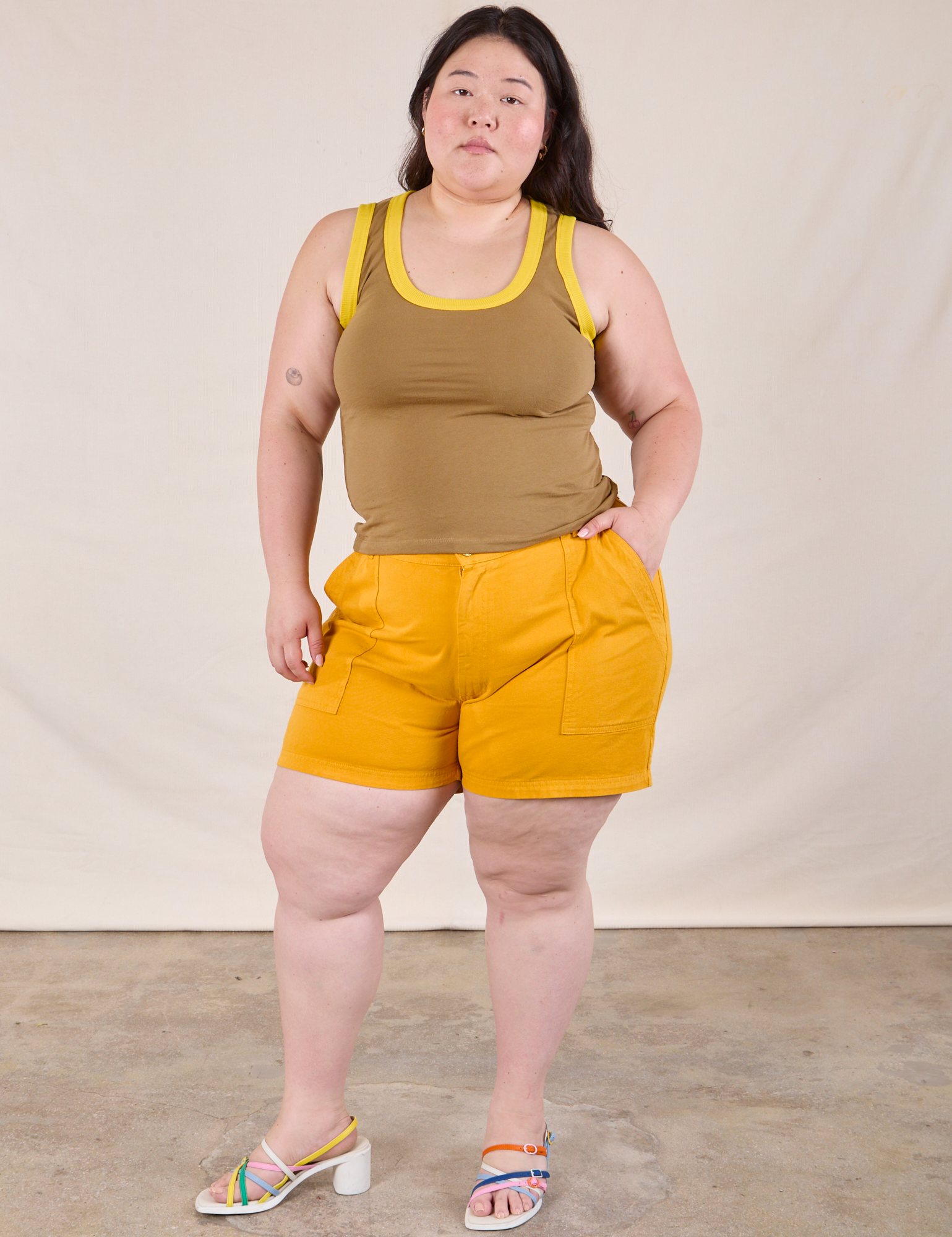 Ashley is wearing Colorblock Cropped Tank in Desert Brown and mustard yellow Work Shorts