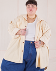 Jordan is wearing Corduroy Overshirt in Vintage Off-White with a vintage off-white Cropped Tank Top underneath and dark wash Denim Trouser Jeans