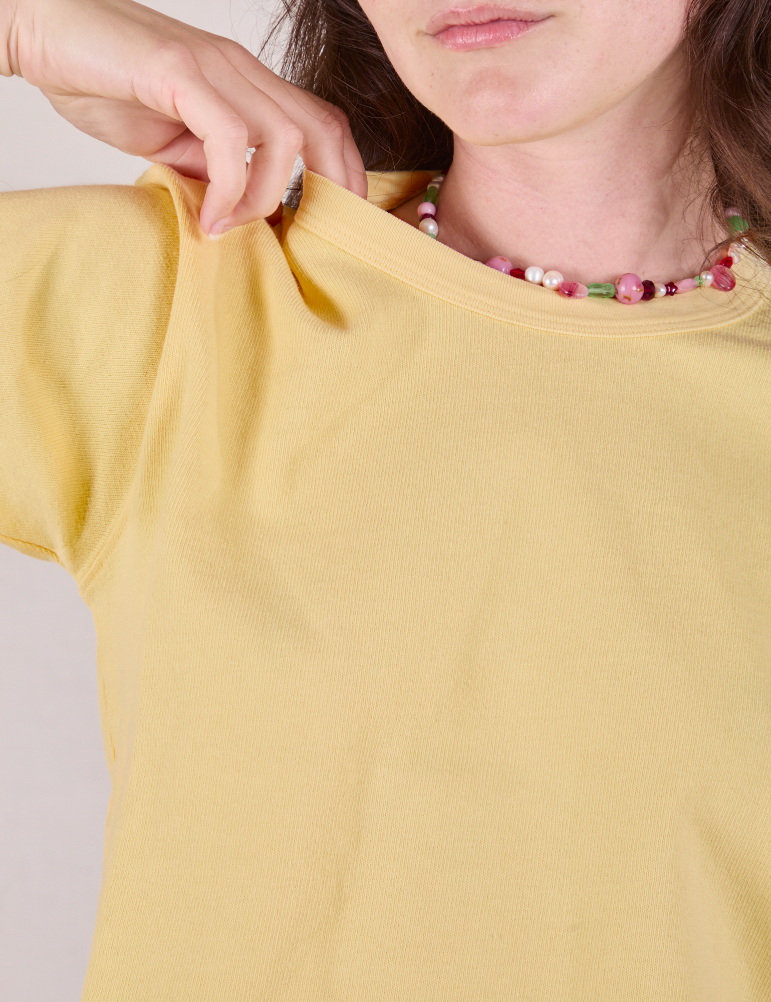 Cropped Burly Tee in Butter Yellow close up on Alex