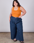 Ashley is wearing Cropped Tank Top in Creamsicle Orange paired with dark wash Indigo Wide Leg Trousers