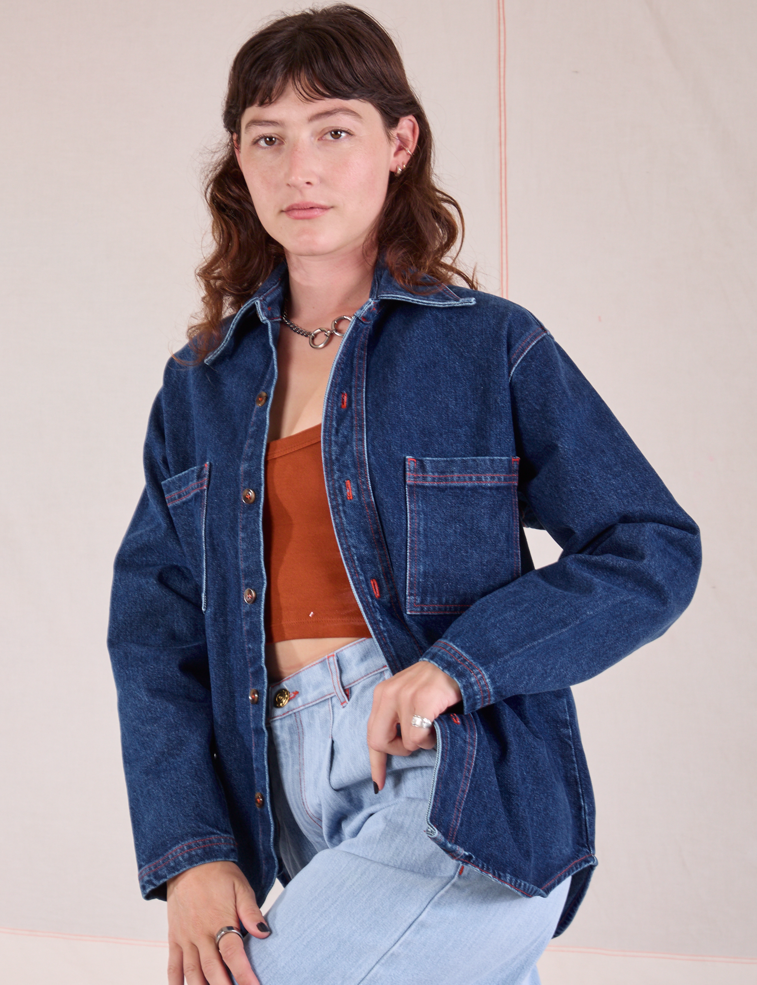 Alex is wearing Denim Overshirt in Dark Wash with a burnt terracotta Cropped Tank