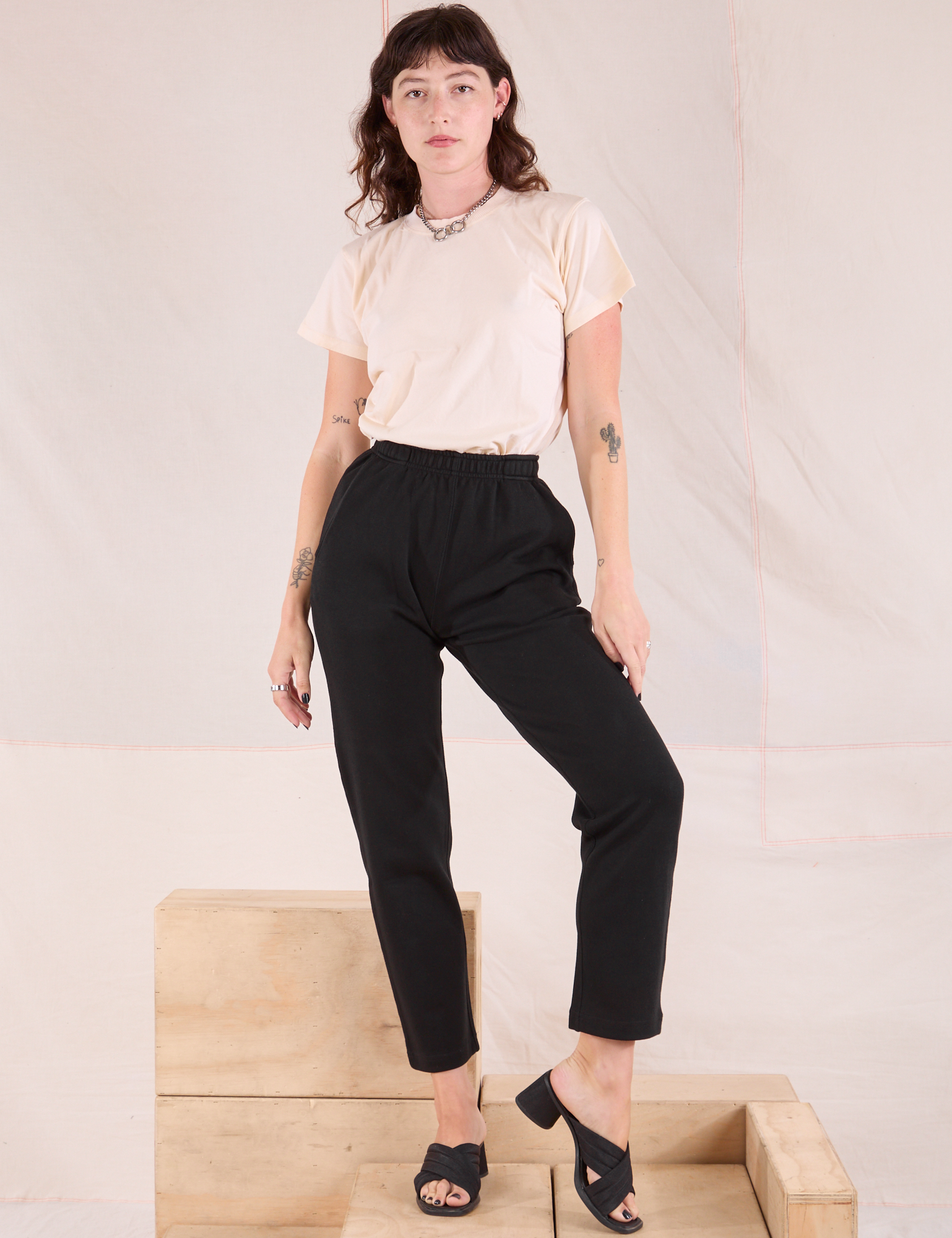 Alex is wearing Easy Pants in Basic Black and Organic Vintage Tee in vintage tee off-white