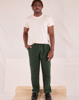 Issac is wearing Easy Pants in Swamp Green and Organic Vintage Tee in Vintage Tee Off-White