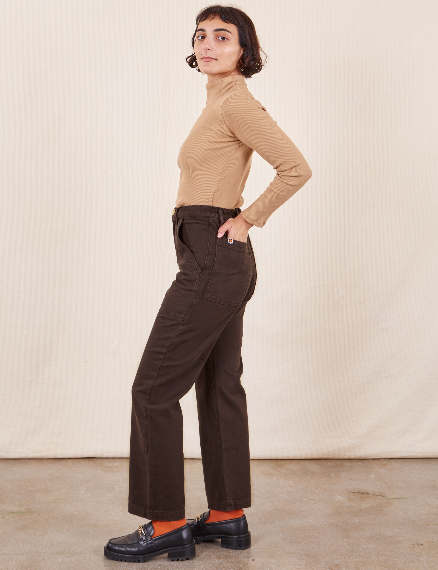 Work Pants in Espresso Brown side view on Soraya wearing tan Essential Turtleneck