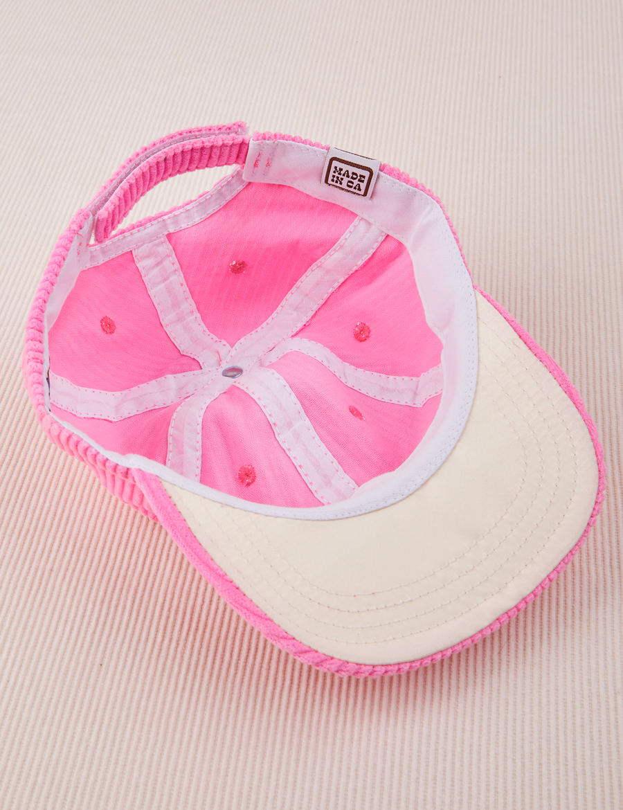 Inside look of Dugout Corduroy Hat in Bubblegum Pink. White Satin underbill.