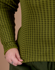 Gingham Long Sleeve Baby Tee in Summer Olive bottom close up with Juliet holding the hem