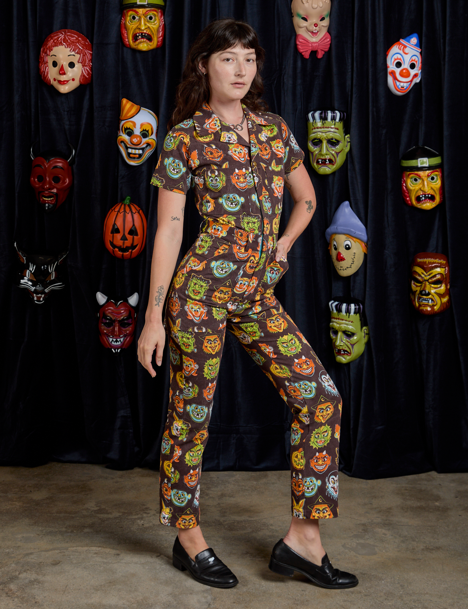 Short Sleeve Jumpsuit in Halloween Masks angled front view on Alex