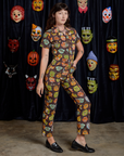 Short Sleeve Jumpsuit in Halloween Masks angled front view on Alex