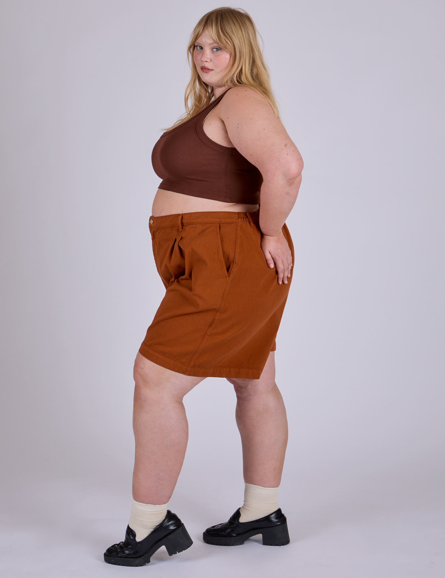 Side view of Pleated Trouser Shorts in Burnt Terracotta and fudgesicle brown Mini Tank on Juliet
