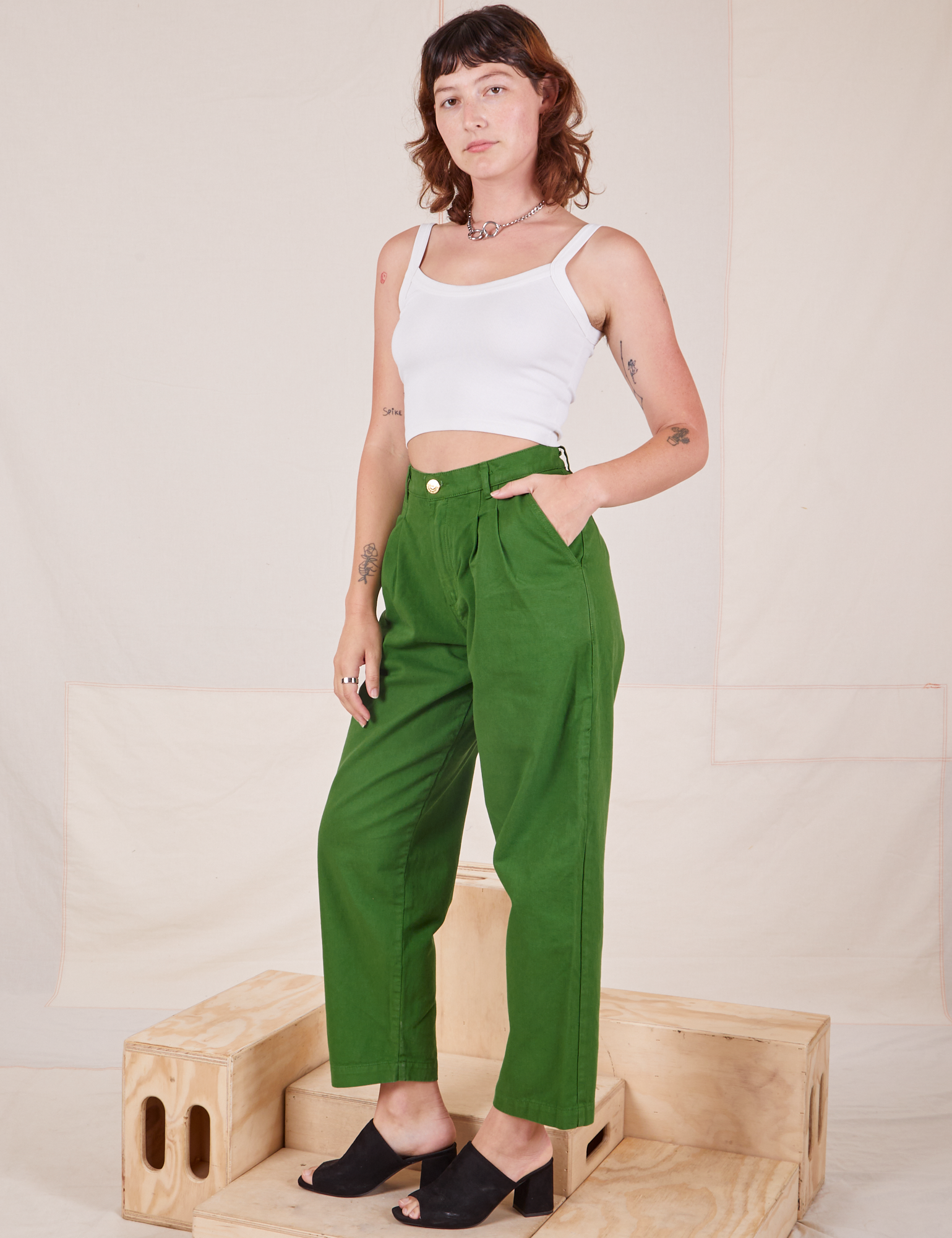 Angled view of Heavyweight Trousers in Lawn Green and vintage off-white Cropped Cami worn by Alex