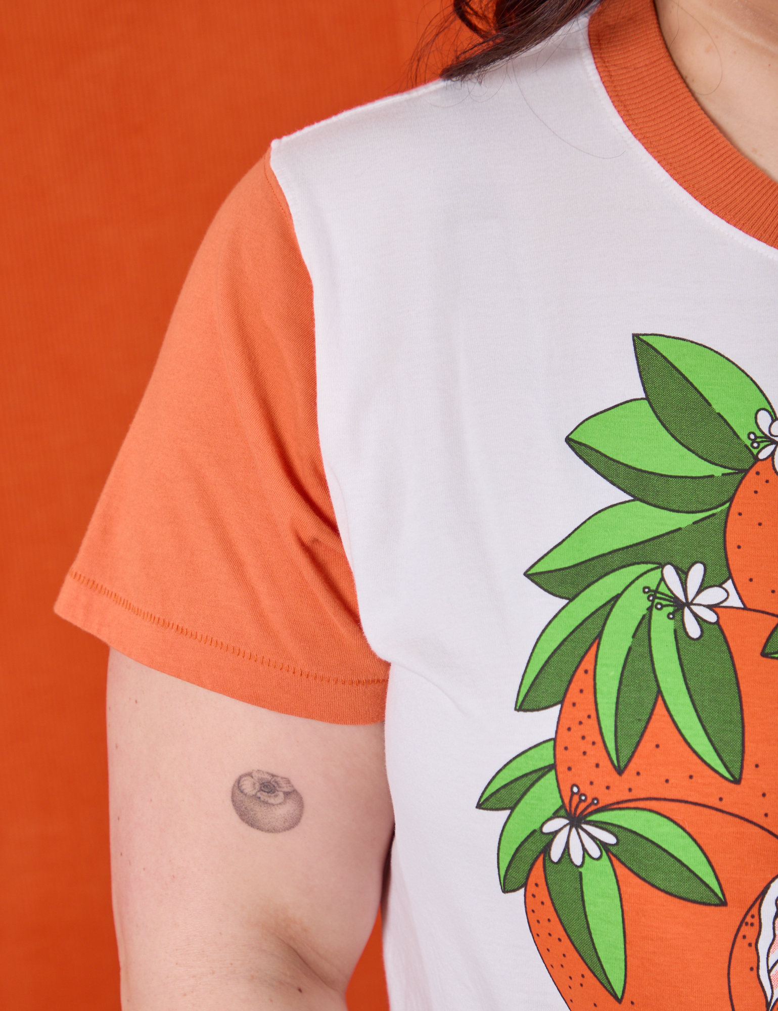 Anniversary Tee in Orange Blossom shoulder close up on Ashley