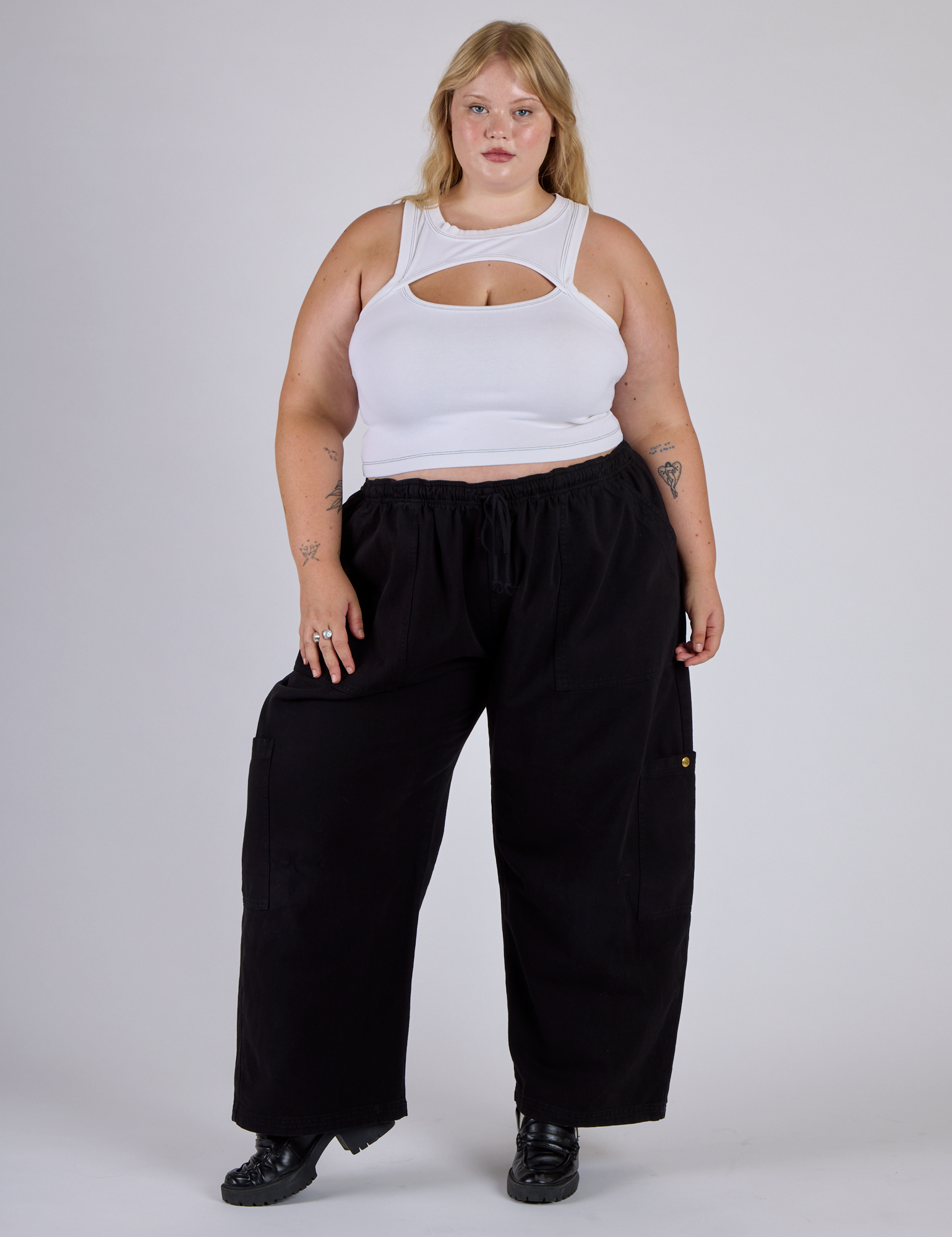 Juliet is wearing the Vintage Tee White Porthole Tank and Black Drop Pocket Cargo Pants