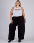 Juliet is wearing the Vintage Tee White Porthole Tank and Black Drop Pocket Cargo Pants