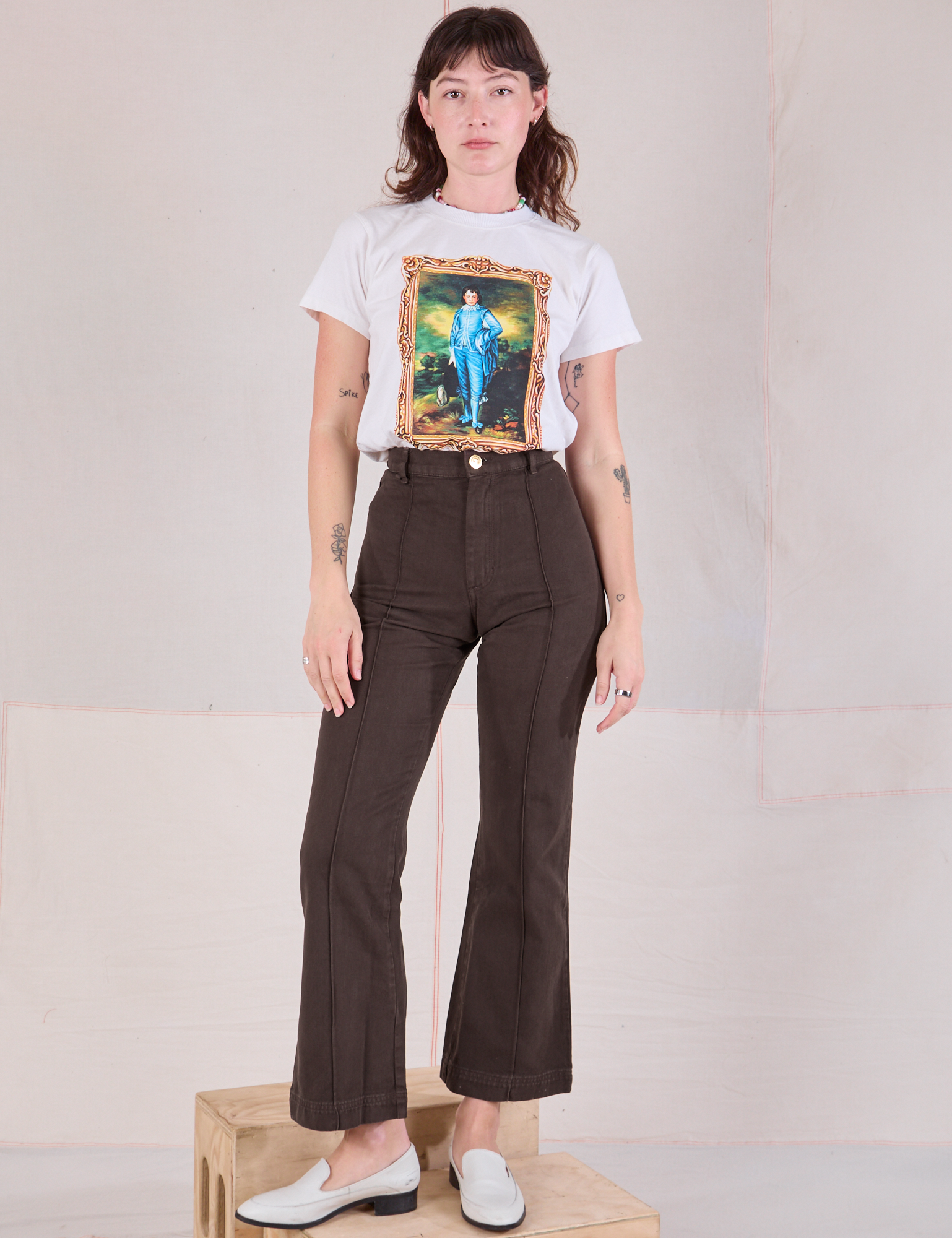 Alex is wearing Masters Organic Tee in Blue Boy tucked into espresso brown Western Pants