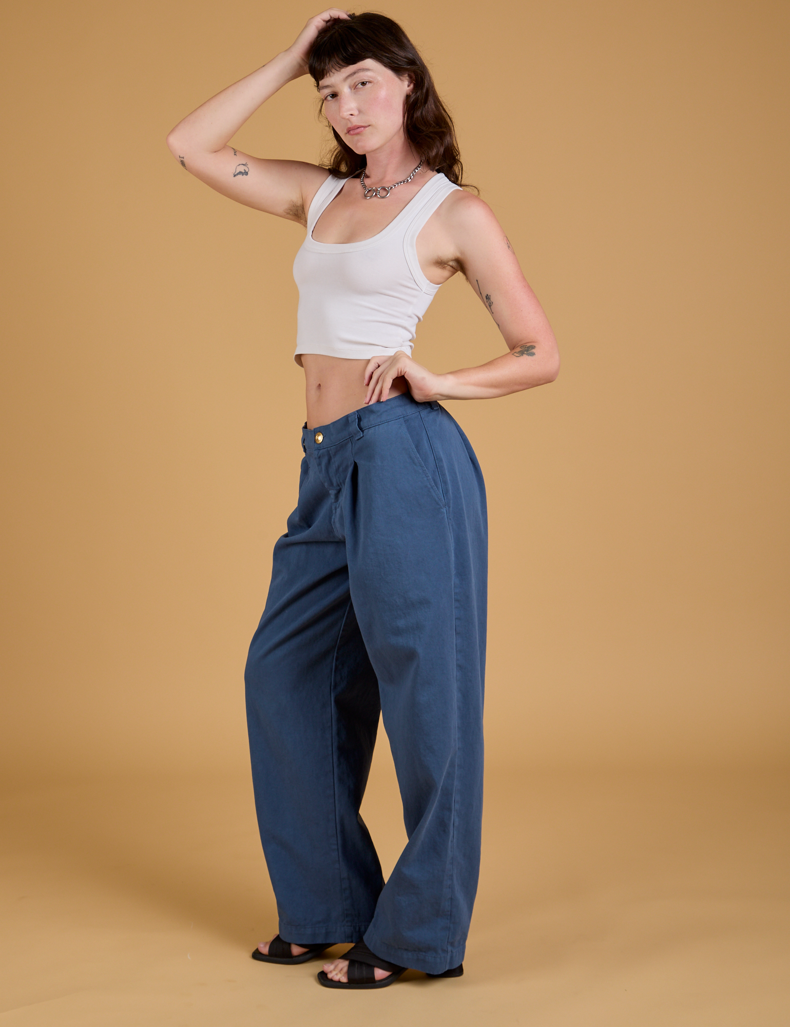 Side view of Baggy Mid-Rise Trousers in French Blue and vintage tee white Cropped Tank on Alex