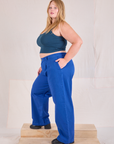 Side view of Mid-Rise Pleated Trousers in Royal Blue and lagoon Cropped Tank on Juliet