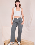 Alex is wearing Mid-Rise Pleated Trousers in Slate Grey and Cropped Tank in vintage tee off-white