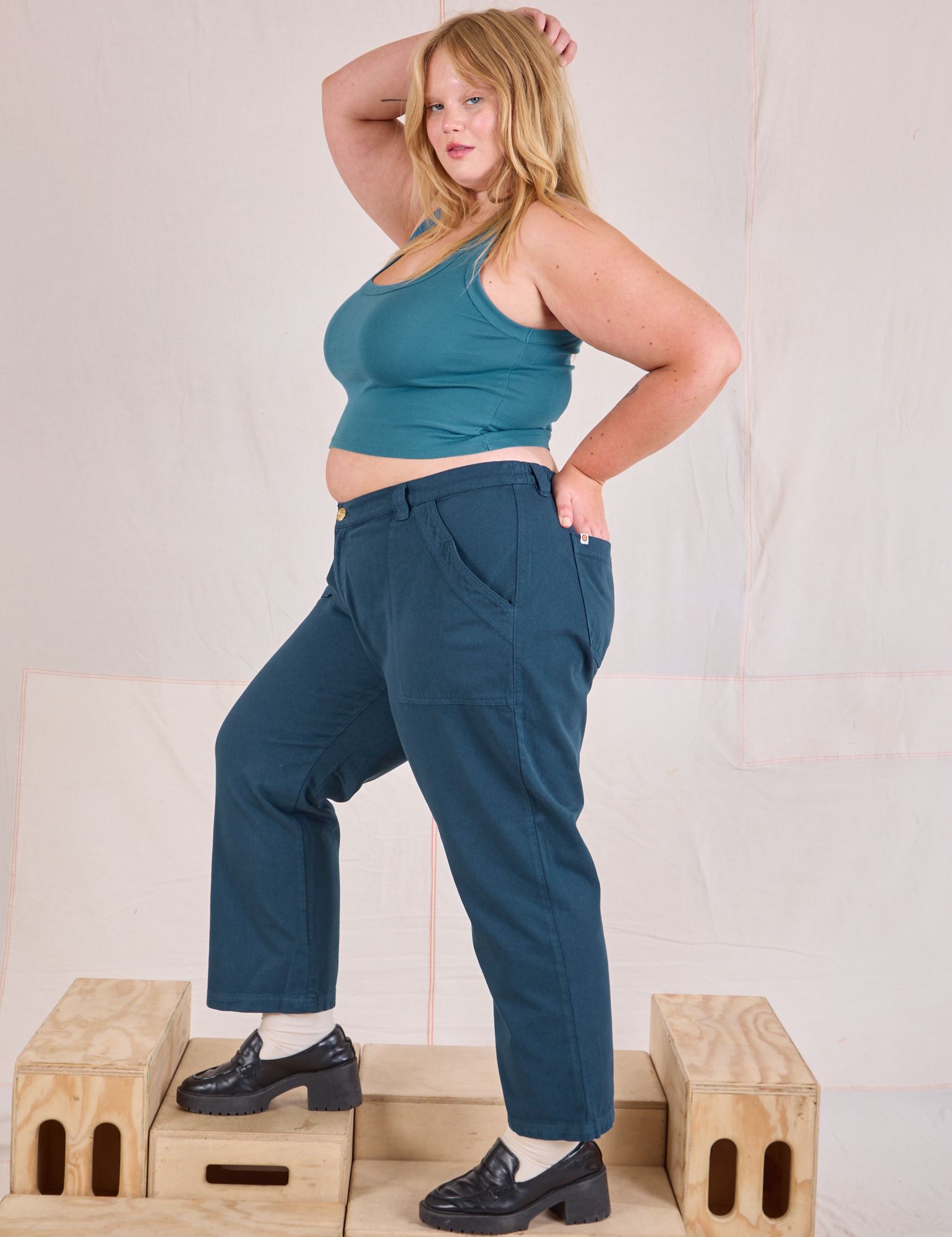 Side view of Mid-Rise Work Pants in Lagoon and marine blue Cropped Tank on Juliet