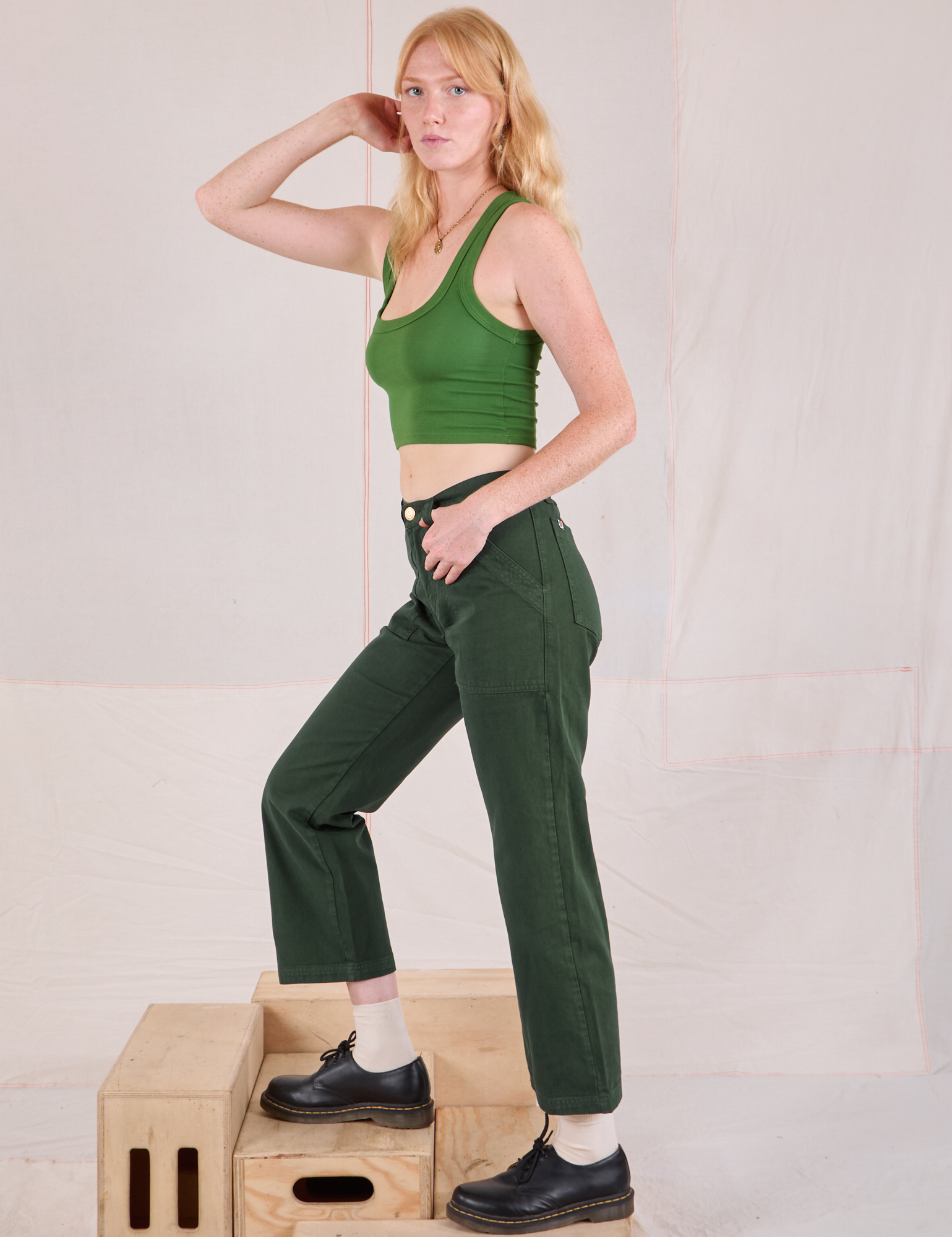 Side view of Mid-Rise Work Pants in Swamp Green and lawn green Cropped Tank on Margaret