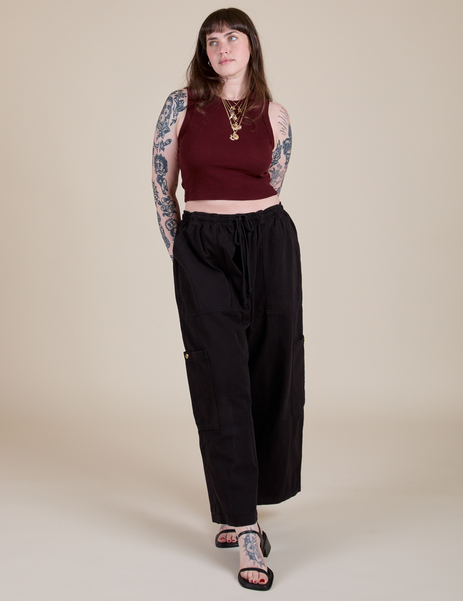 Sydney is wearing  Muscle Tee in Red Wineand black Drop Pocket Cargo Pants