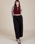 Sydney is wearing  Muscle Tee in Red Wineand black Drop Pocket Cargo Pants