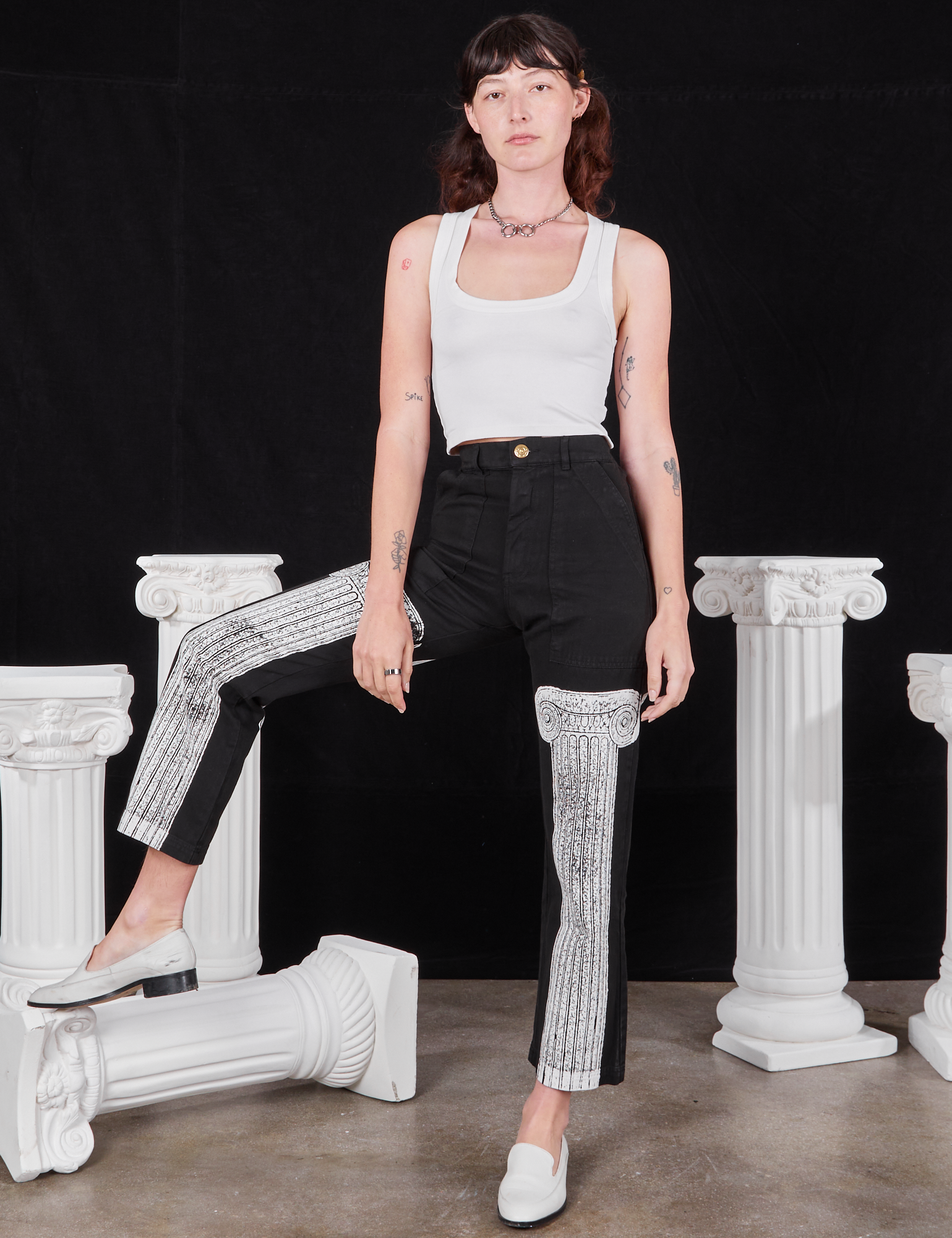 Alex is wearing Column Work Pants in Basic Black and vintage off-white Cropped Tank Top