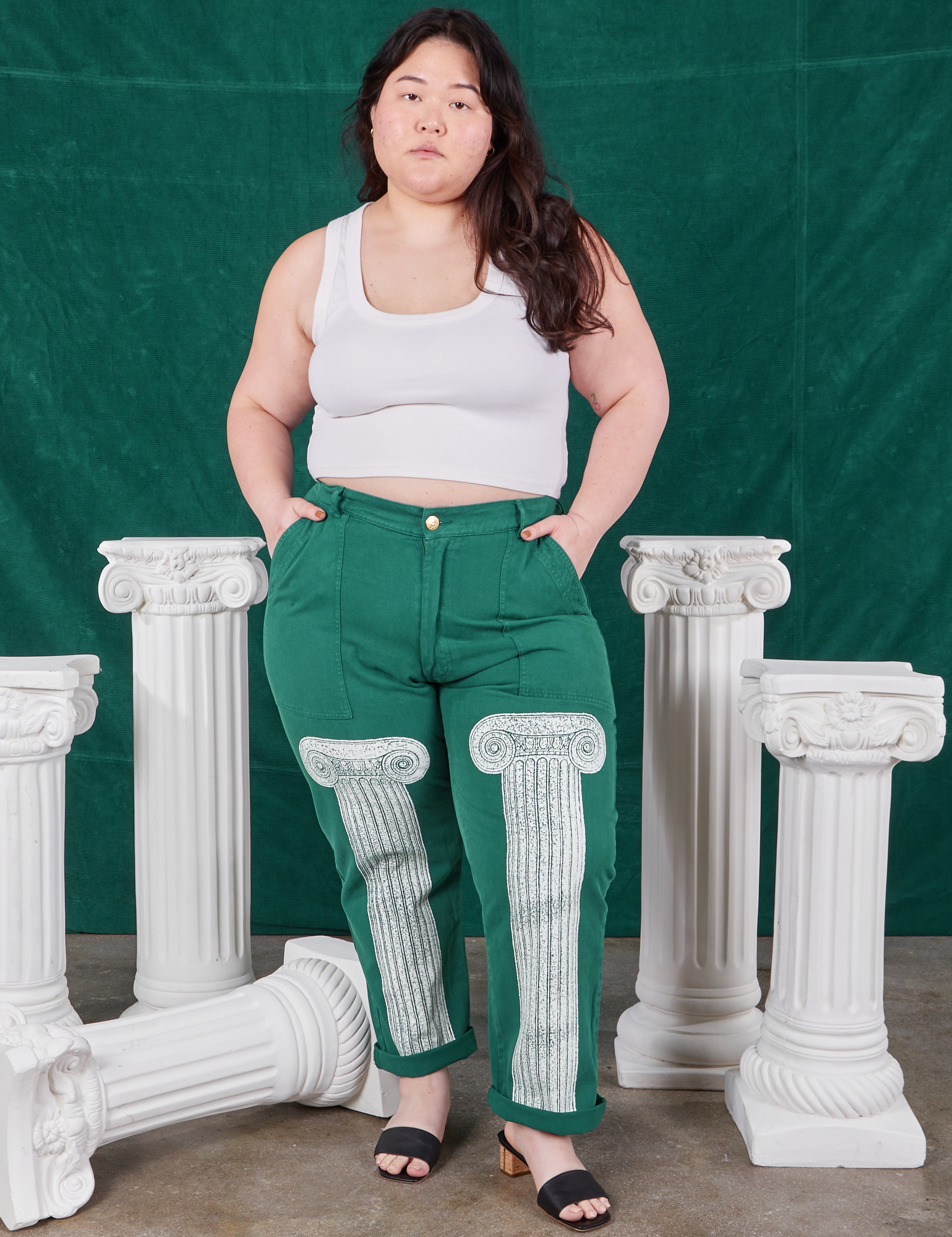 Ashley is wearing Column Work Pants in Hunter Green and vintage off-white Cropped Tank Top