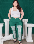 Ashley is wearing Column Work Pants in Hunter Green and vintage off-white Cropped Tank Top