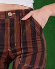 Black Stripe Work Pants in Fudgesicle Brown front pocket close up. Alex has her hand in the pocket.