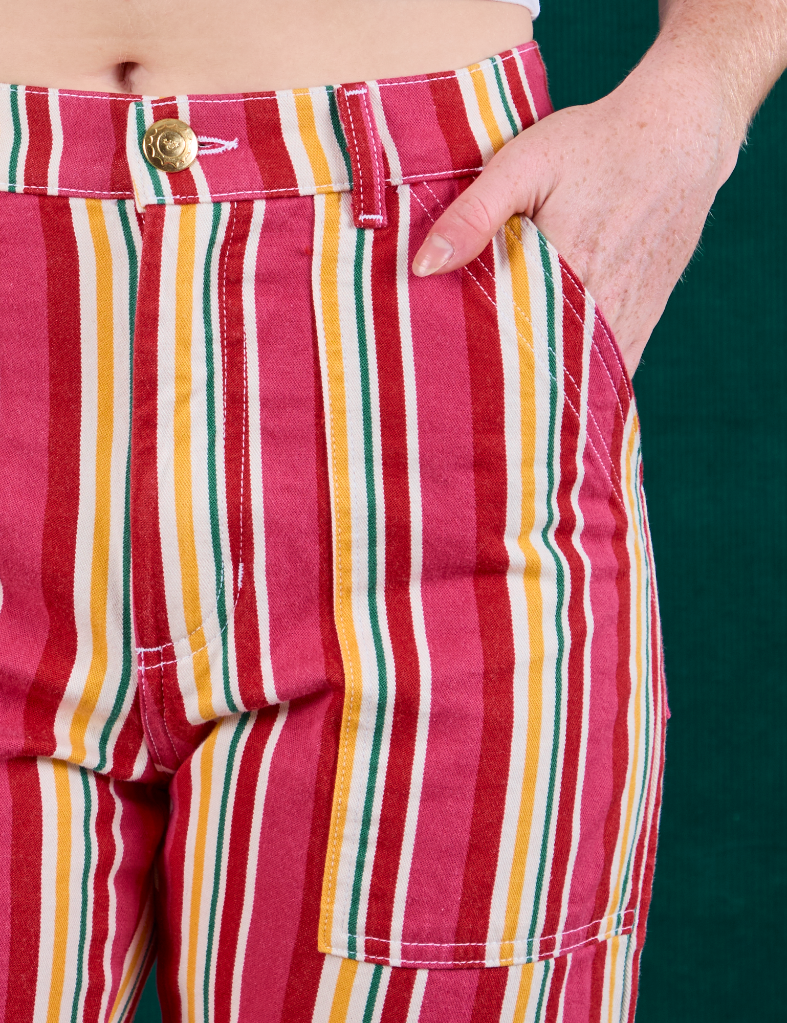 Stripe Work Pants in Cherry Candy front close up. Margaret has her hand in the pocket.