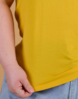 Organic Vintage Tee in Sunshine Yellow bottom close up with Ashley holding hem