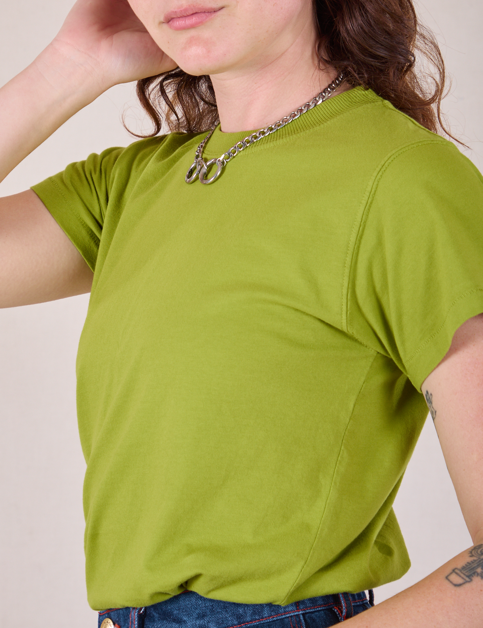 Angled front close up of Organic Vintage Tee in Gross Green on Alex