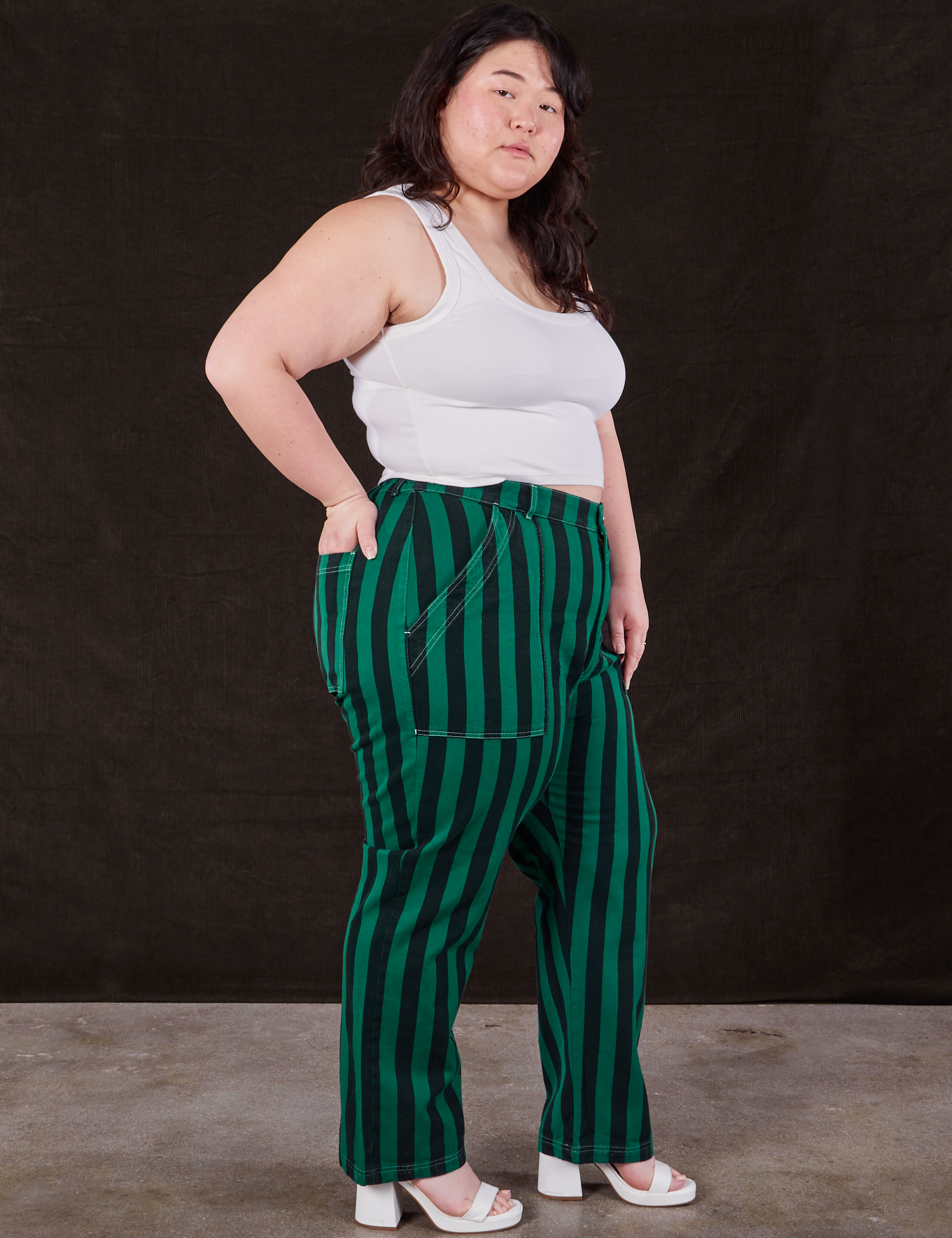Side view of Black Stripe Work Pants in Hunter and vintage off-white Cropped Tank Top