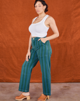 Angled front view of Overdye Stripe Work Pants in Blue/Green and vintage off-white Cropped Tank Top on Tiara