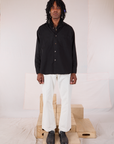 Jerrod is wearing a buttoned up Twill Overshirt in Basic Black with vintage tee off-white Western Pants