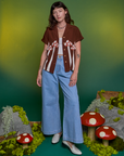 Alex is wearing Paintstamped Pantry Button-Up in Mushroom and light wash Indigo Wide Leg Trousers