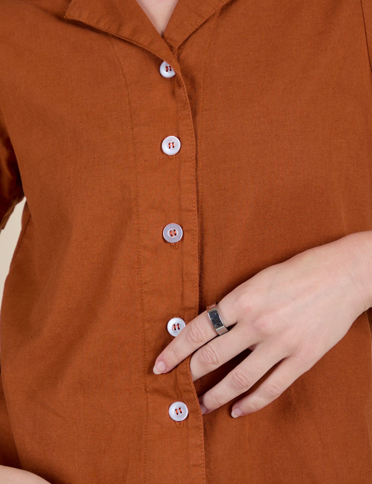 Front close up of Pantry Button-Up in Burnt Terracotta with white buttons on Alex