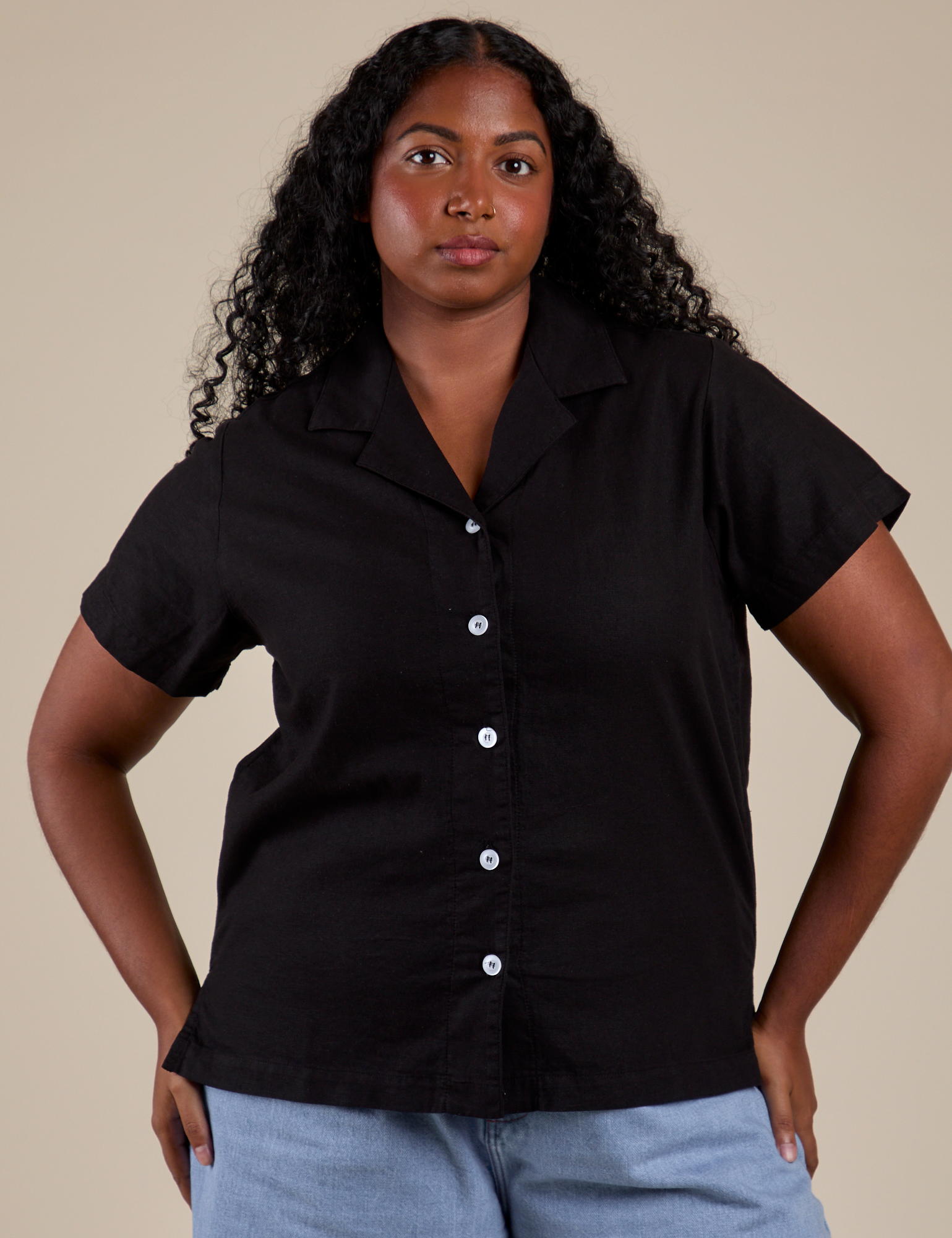 Meghna is wearing a buttoned up Pantry Button-Up in Basic Black