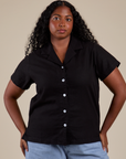 Meghna is wearing a buttoned up Pantry Button-Up in Basic Black