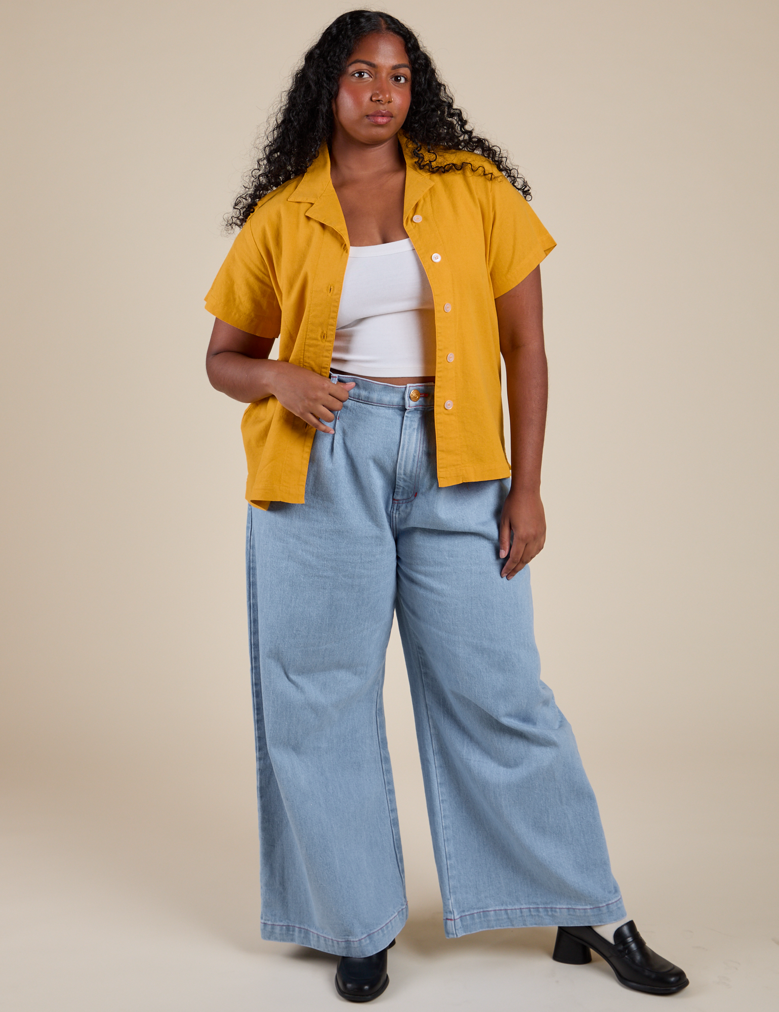 Meghna is wearing Pantry Button-Up in Mustard Yellow and light wash Indigo Wide Leg Trousers