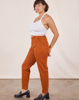Side view of Pencil Pants in Burnt Terracotta and vintage off-white Halter Top on Tiara