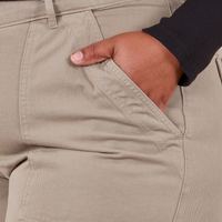 Front pocket close up of Work Pants in Khaki Grey. Worn by Morgan with her hand in the pocket