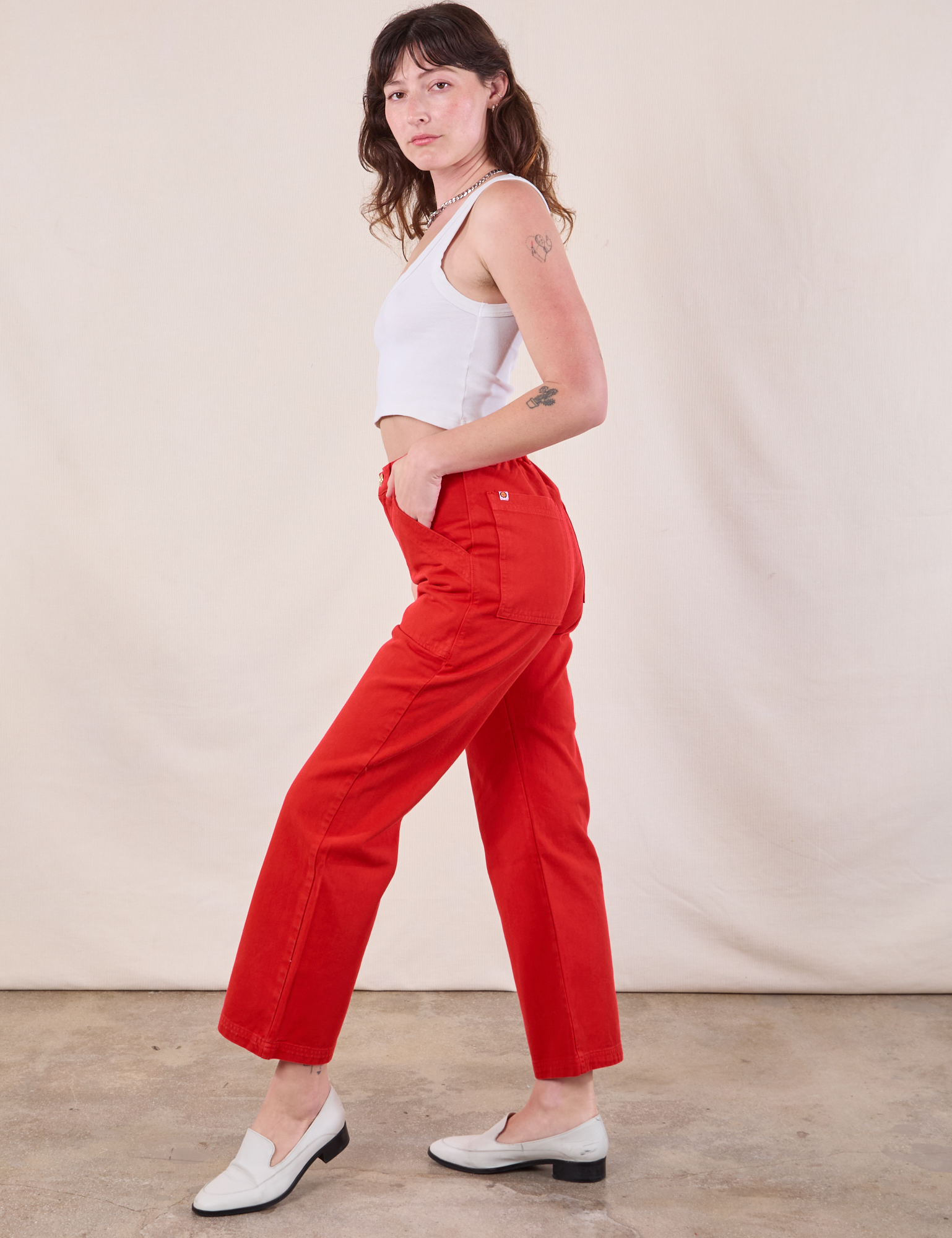 Side view of Work Pants in Mustang Red and Cropped Tank in vintage tee off-white