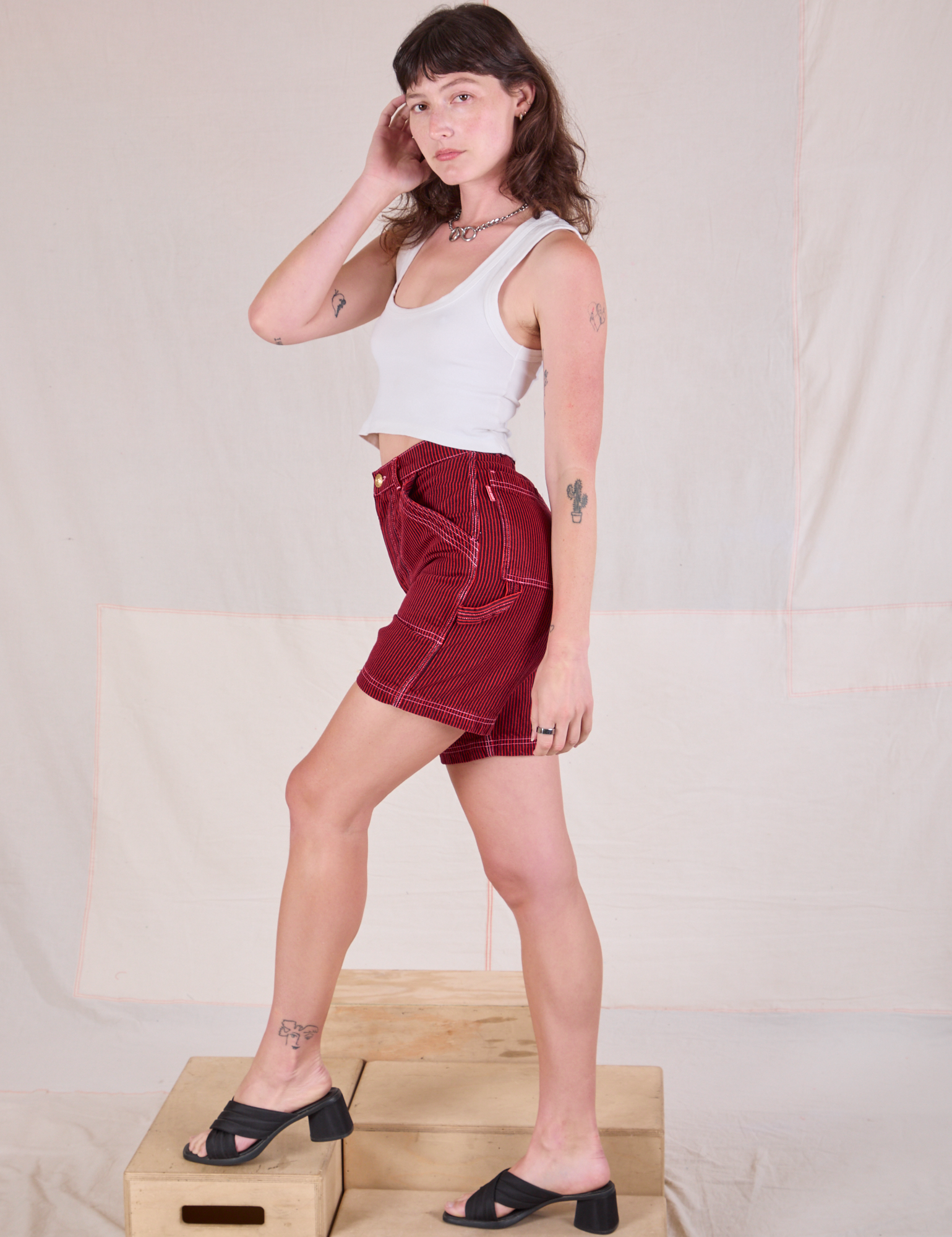 Side view of Railroad Carpenter Shorts in Mustang Red and Cropped Tank in Vintage Tee Off-White