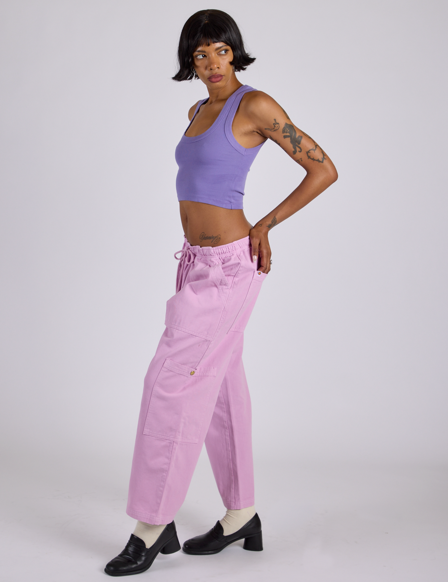 Side view of Drop Pocket Cargo Pants in Lilac Purple and faded grape Cropped Tank on Kira
