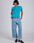 Kira is wearing Jr. Varsity Tee in Hawaiian Blue and light wash Denim Drop Pocket Pants