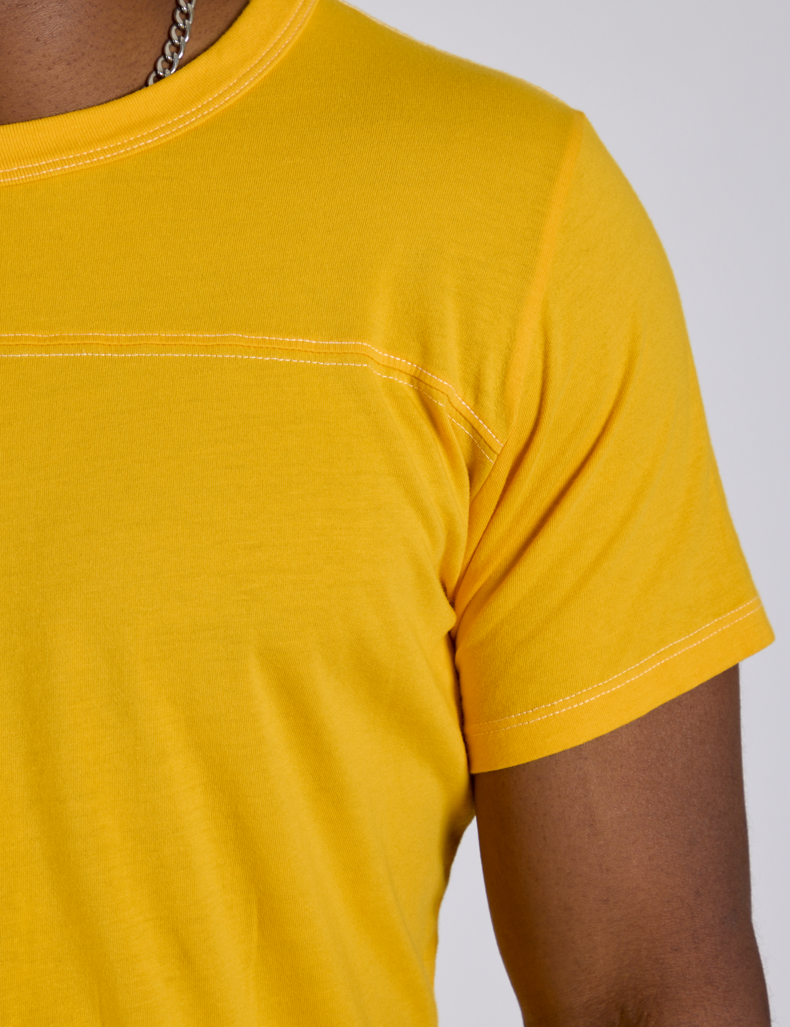 Shoulder close up of Jr. Varsity Tee in Sunshine Yellow on Isaac