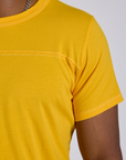 Shoulder close up of Jr. Varsity Tee in Sunshine Yellow on Isaac